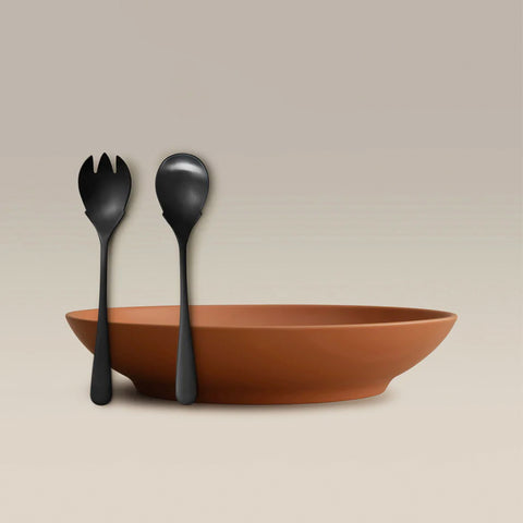 All Is Served Set with two black utensils beside a terracotta bowl