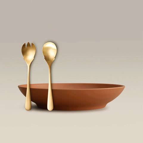 All Is Served Set featuring two gold utensils beside a terracotta bowl