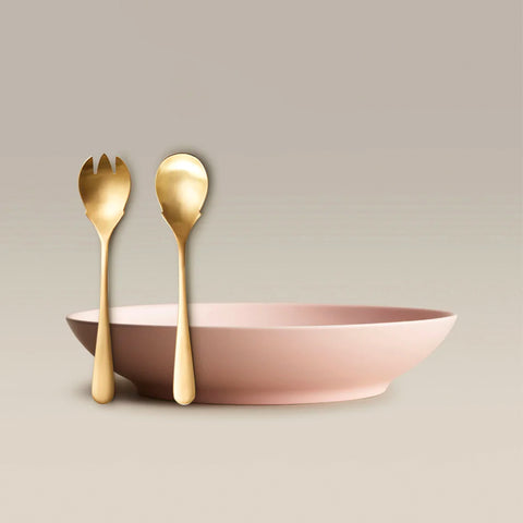 All Is Served Set with a soft pink bowl and tall gold fork and spoon resting beside it