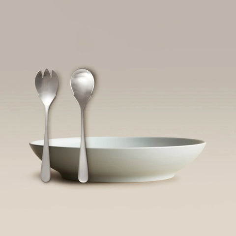 All Is Served Set fork and spoon leaning against a white shallow bowl