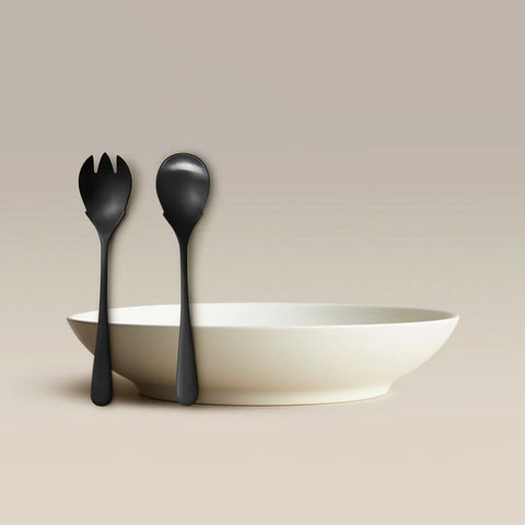 All Is Served Set black fork and spoon leaning against a white bowl