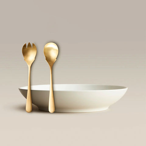 All Is Served Set gold spork and spoon resting beside a white bowl