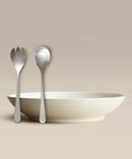 All Is Served Set features a white bowl with two silver utensils standing against a neutral backdrop