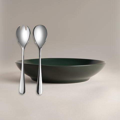 All Is Served Set two silver utensils stand beside a dark green bowl.