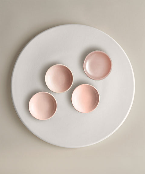 Four blush pink bowls arranged on a white plate from The Party Starter Set.