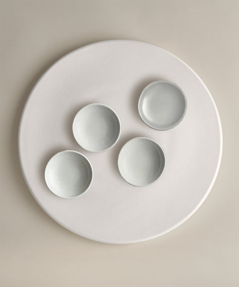 Light gray ceramic bowls arranged on a large white round platter from The Party Starter Set